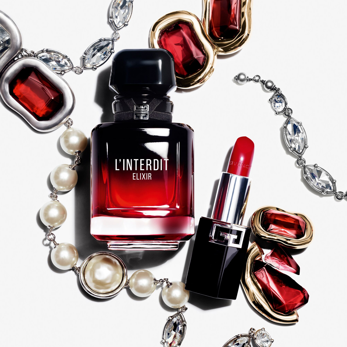Givenchy L'Interdit Elixir fragrance bottle with red gemstones, pearls and lipstick