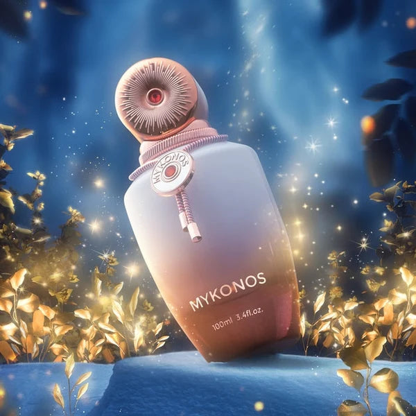 Mykonos perfume bottle in a blue wintry setting surrounded by golden foliage